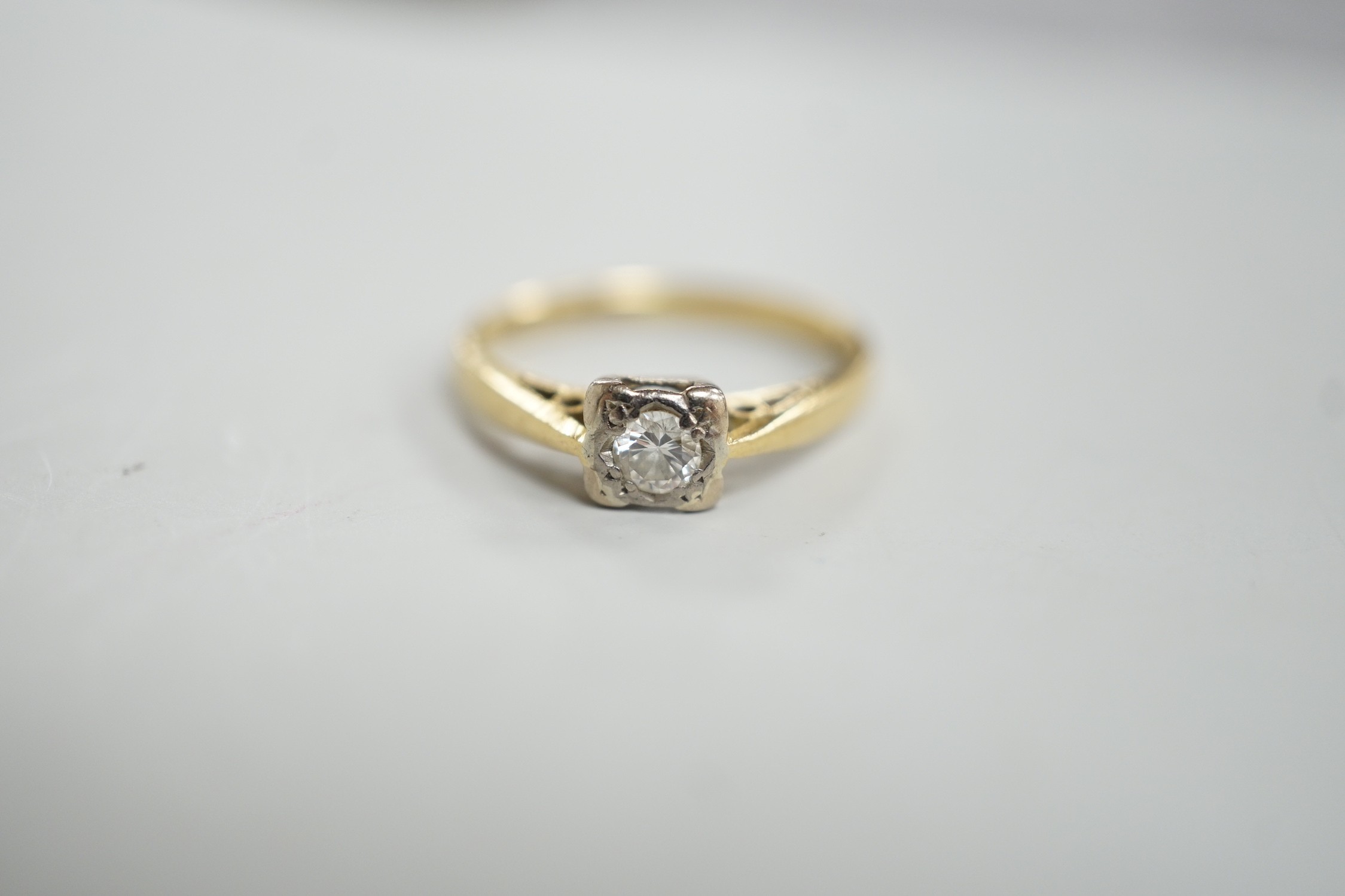 A modern 18ct gold and solitaire diamond ring, size K, gross weight 2.3 grams.